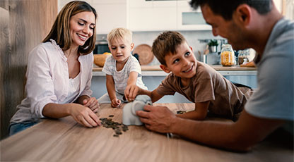 Image of a family putting coins into a piggy bank