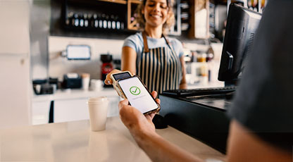 Person tapping with their phone to pay