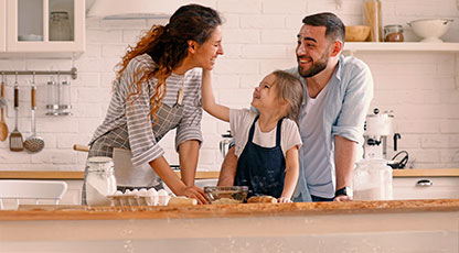 Family making cookies in kitchen