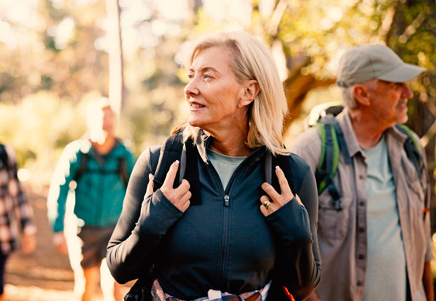 Two people walking in the woods.