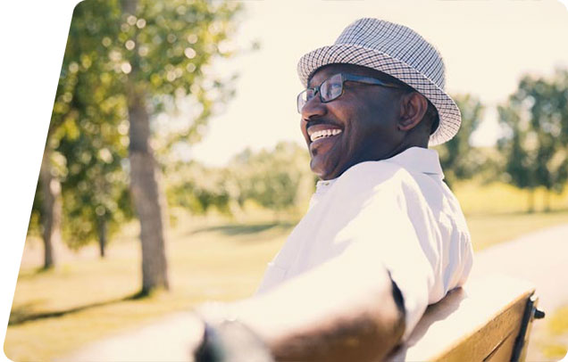 Person sitting at a bench smiling