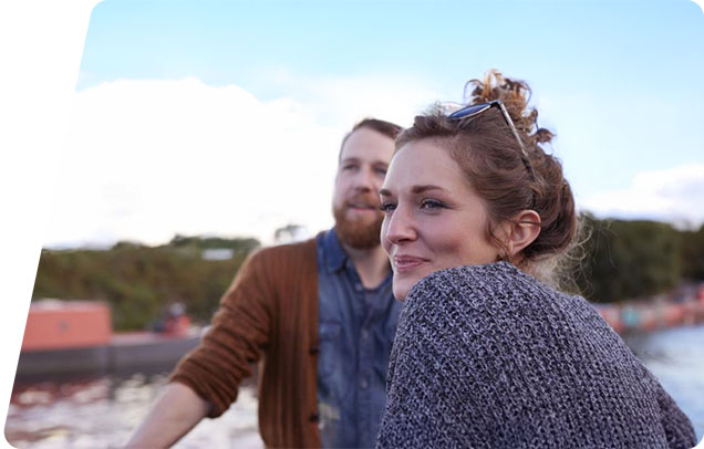 People sitting on the coast and smiling