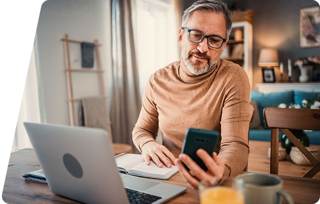 Person working on their laptop and phone