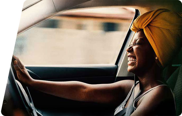 adult laughing while driving