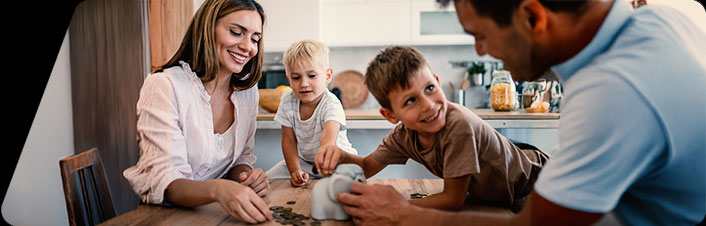 Image of a family putting coins into a piggy bank