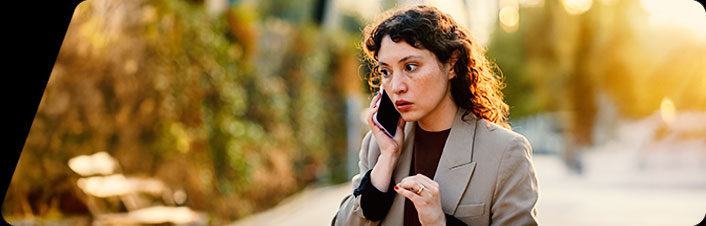 Image of a woman talking on the phone in a park