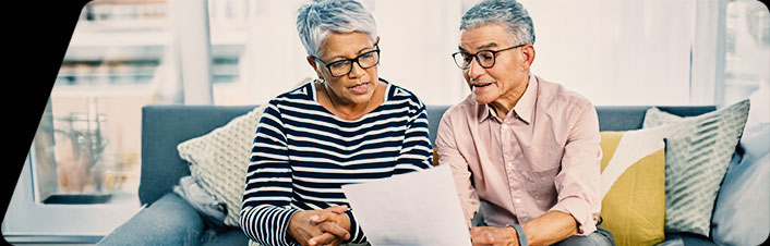 Image of an older man and woman reviewing a document together