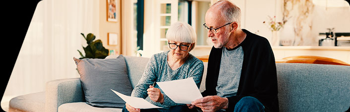 Image of a man and woman looking at document together