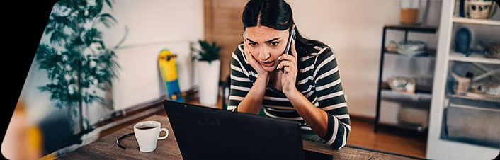 Image of a woman talking on the phone in their home