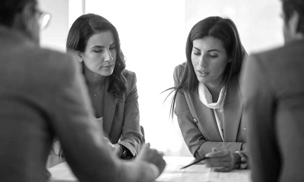 four people in a meeting