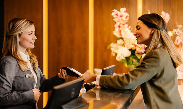 Image of a woman checking into a hotel